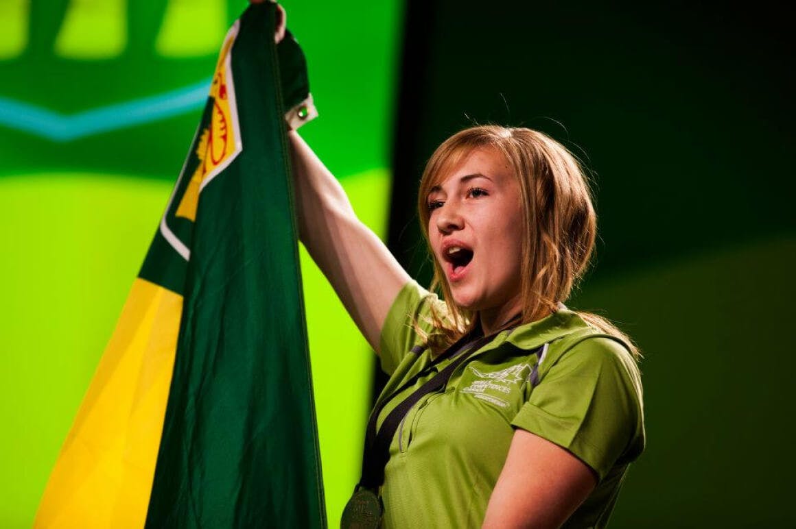 Event photo of student from the province of Saskatchewan celebrating their victory after receiving a medal during the closing ceremony.
