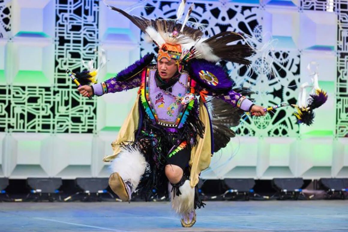 Event photo of an Indigenous dancer performing during the opening ceremony.